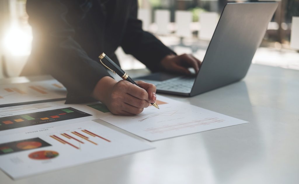 Financial businesswoman calculating corporate income tax data And analyzing charts of financial