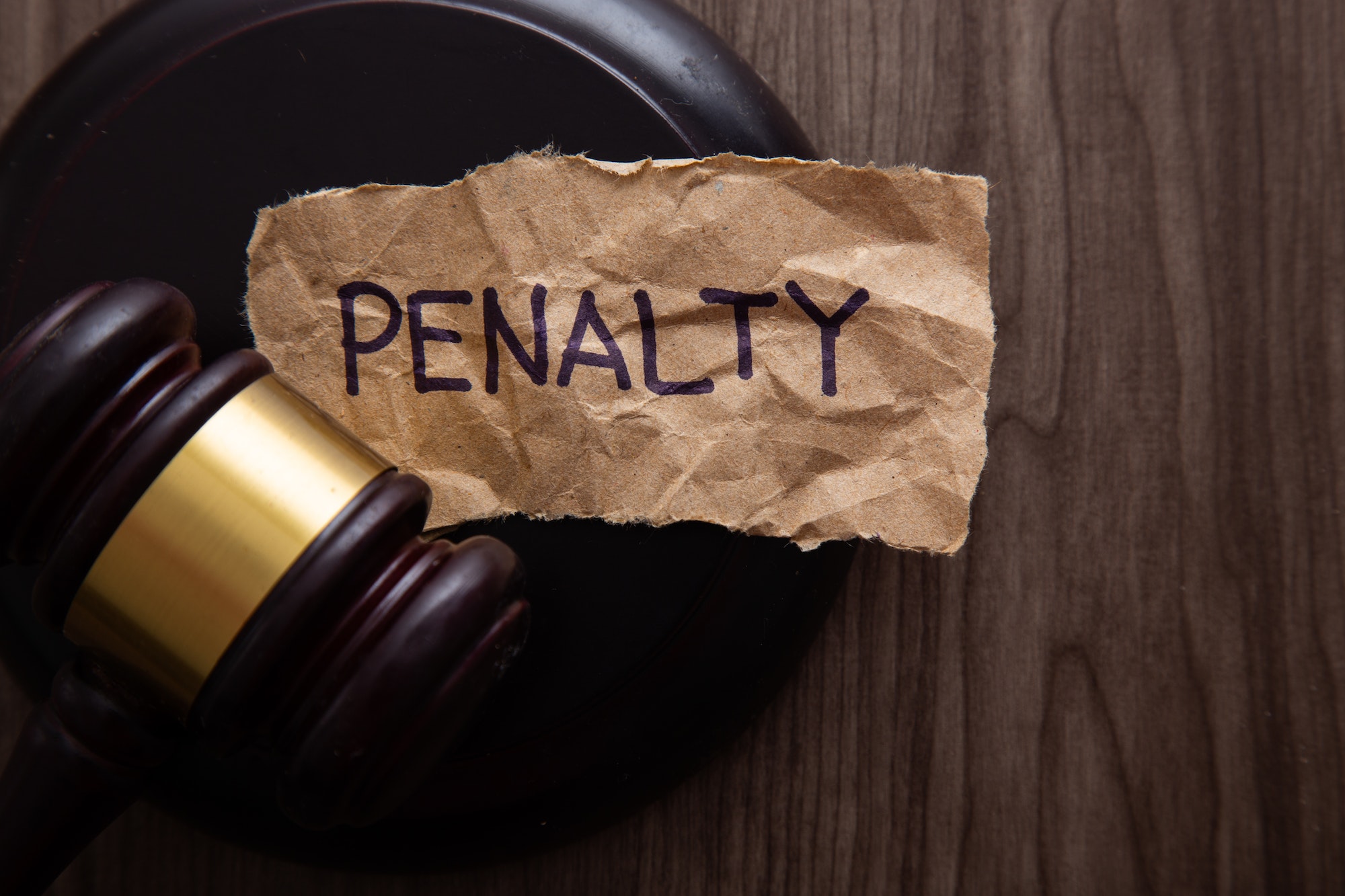 PENALTY wording with gavel on wooden background